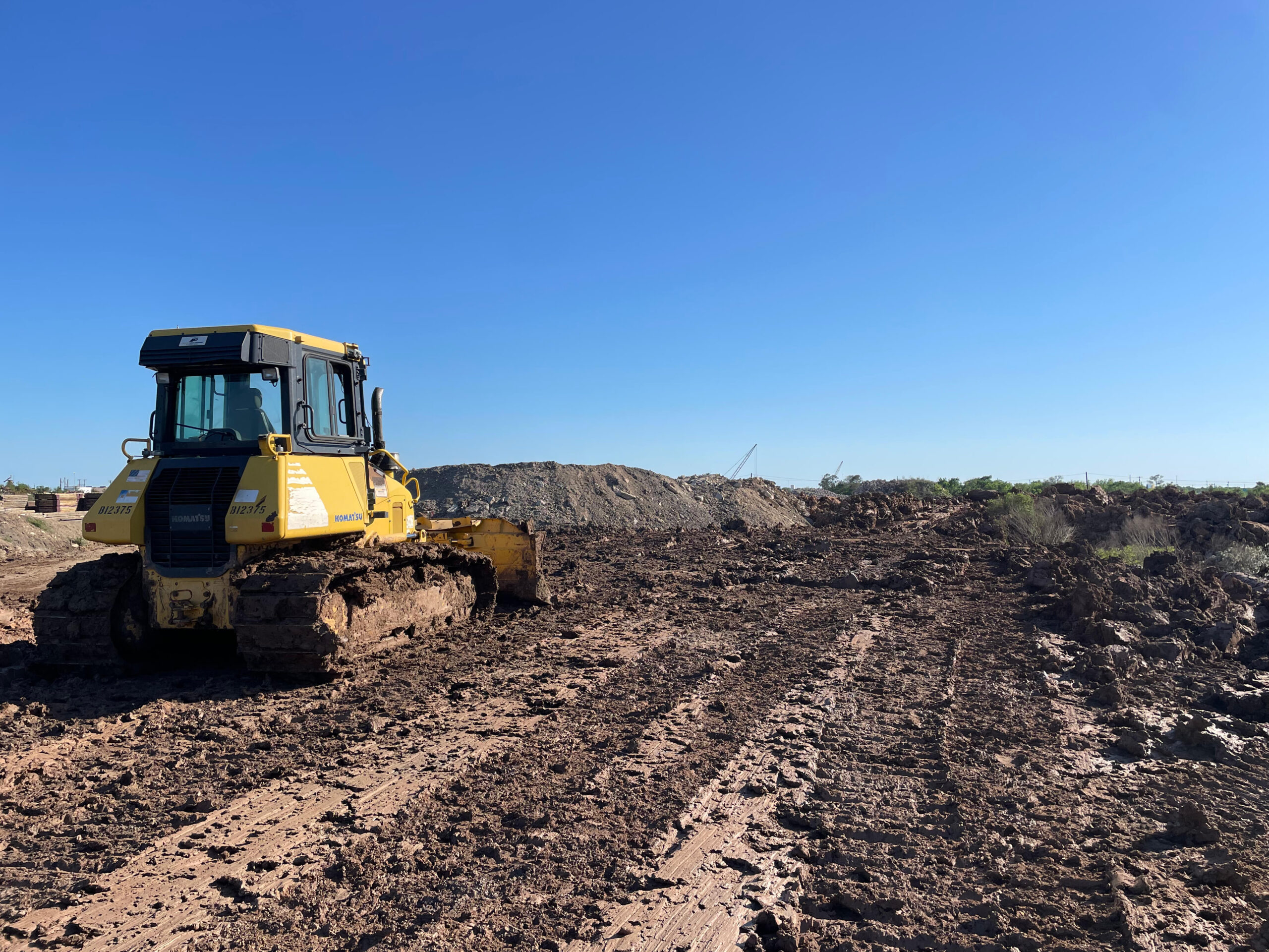 Crane clearing land for construction project