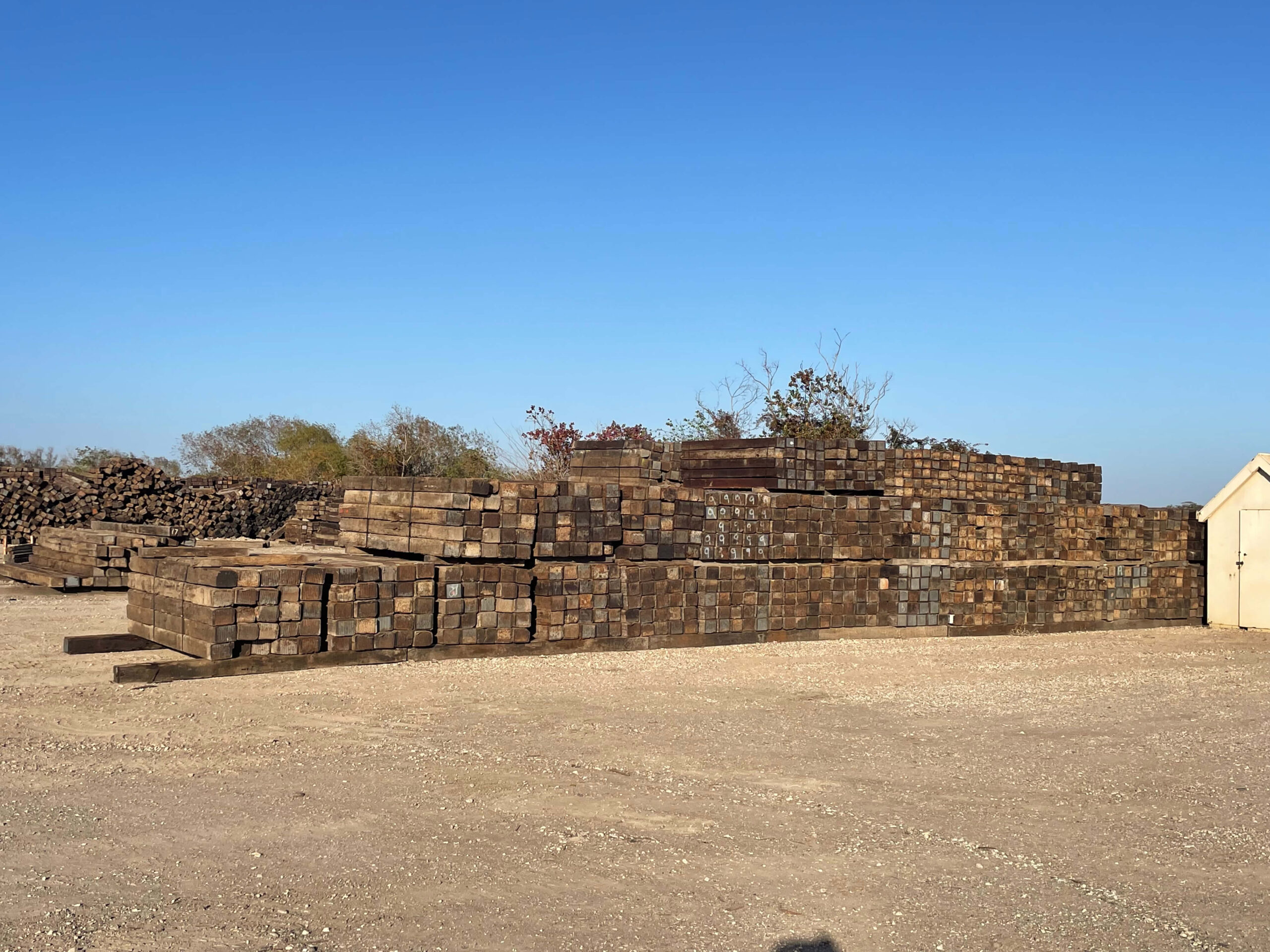 Railroad ties and switch in crane mat yard for sale and rent.